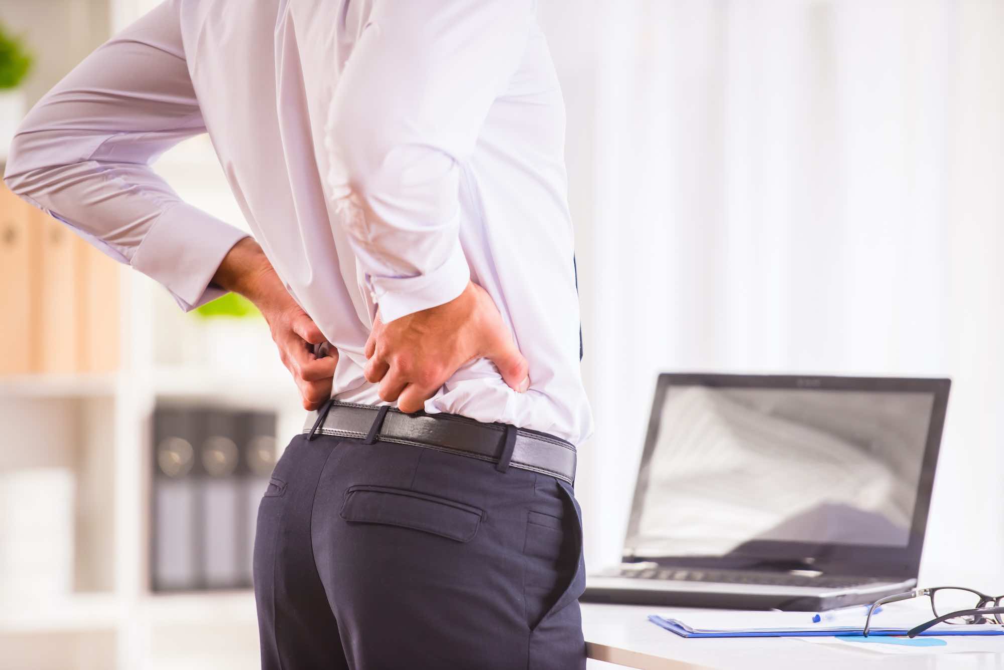 Man by computer with pain in lumbar